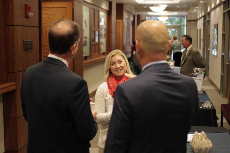 Forum Participants Conversing in Hallway